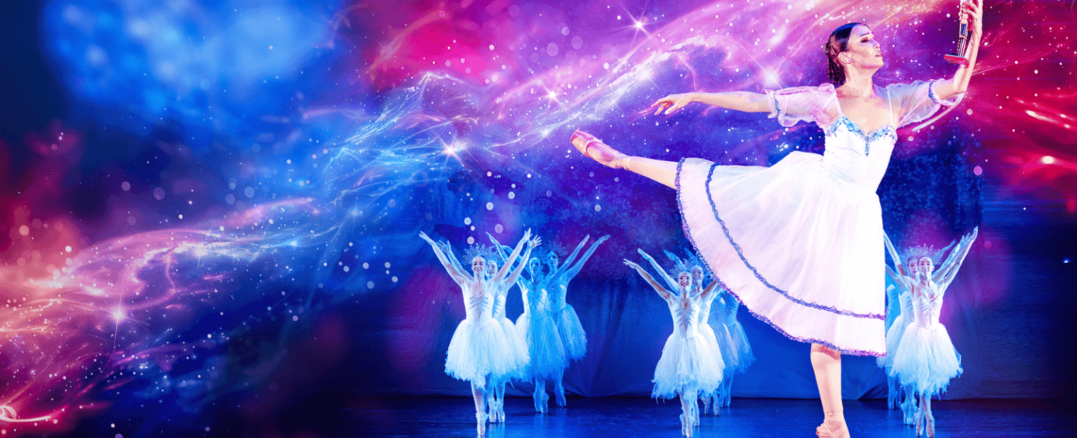 Ballerina, holding a nutcracker, with her leg extended behind her in arabesque