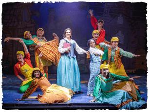 Panto ensemble holding poses in a semi circle with Belle and her brother in the middle 