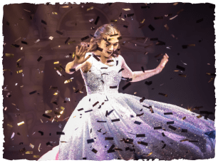 Cinderella (Clair Gleave) turns in sparkly blue dress surrounded by gold confetti