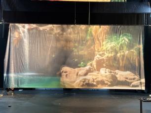 a forest waterfall with a rocky azure pool