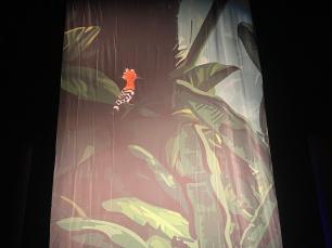 A printed cloth of an exotic bird in a jungle tree