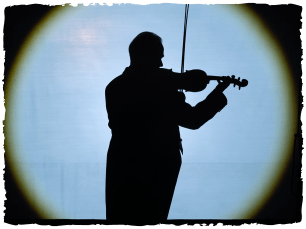 Silhoutte of man playing violin