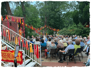 Outdoors stage of Comapny of Rascals, big audience sat watching