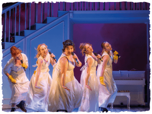 Girls in white nighties singing with mics