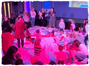 Group of small children and adults in big circle