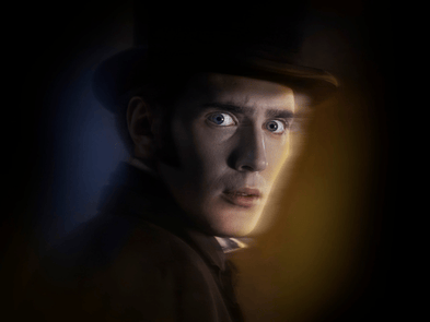 A headshot of a man, he looks scared at the camera, a blue and yellow haze surrounds his head with a dark background, he wears black top had and black coat