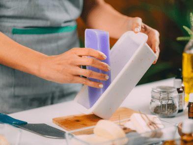 Someone taking purple soap out of a mould