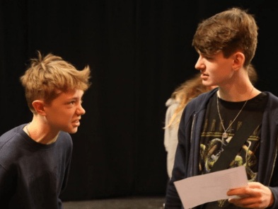 Two boys debating a script together