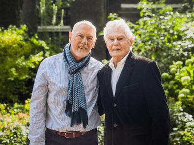 Sir Derek Jacobi and Richard Clifford against a sunny garden background