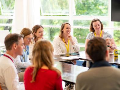 A small group of people sit around a table